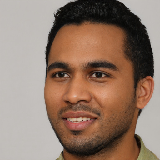 Joyful black young-adult male with short  black hair and brown eyes