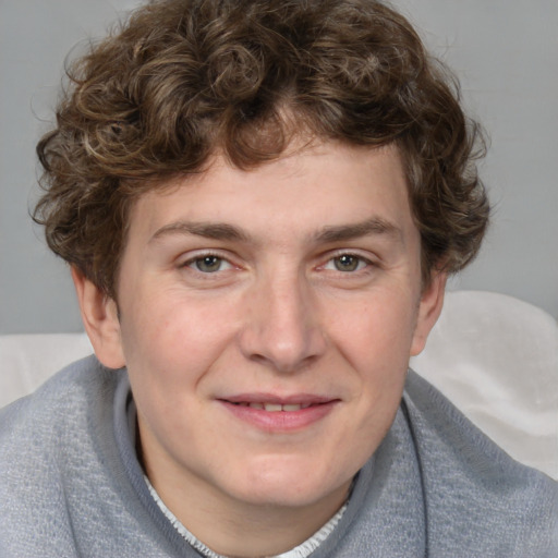 Joyful white young-adult male with short  brown hair and blue eyes