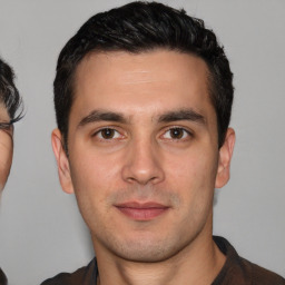 Joyful white young-adult male with short  black hair and brown eyes