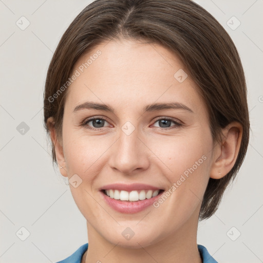 Joyful white young-adult female with medium  brown hair and grey eyes