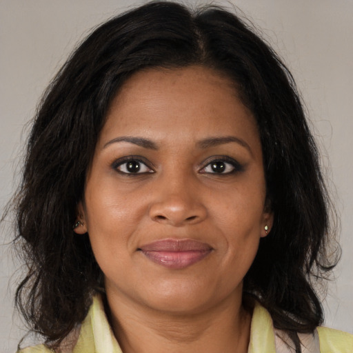 Joyful black young-adult female with medium  brown hair and brown eyes
