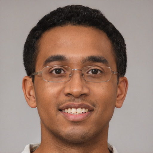 Joyful latino young-adult male with short  brown hair and brown eyes