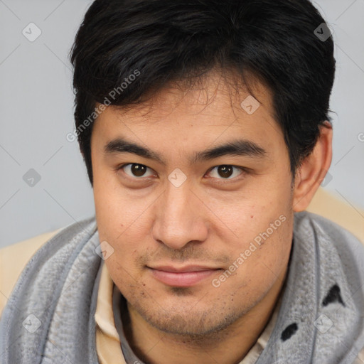 Joyful asian young-adult male with short  brown hair and brown eyes