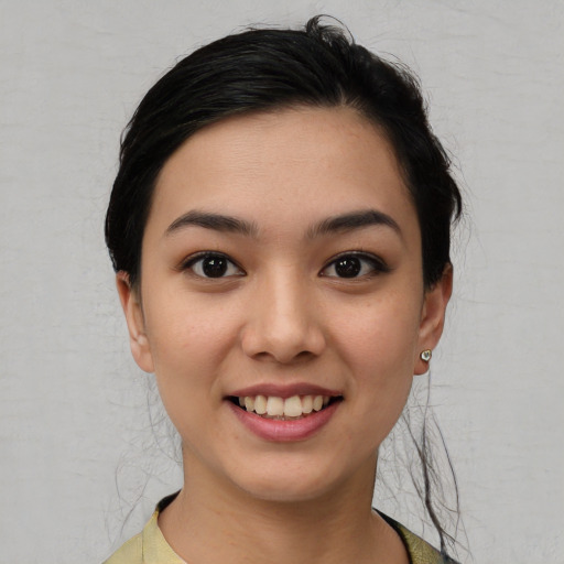 Joyful asian young-adult female with short  brown hair and brown eyes