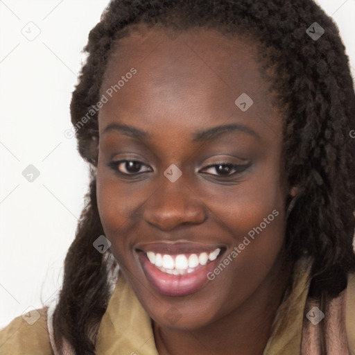 Joyful black young-adult female with long  brown hair and brown eyes