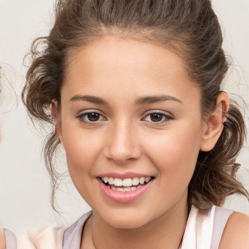 Joyful white child female with medium  brown hair and brown eyes