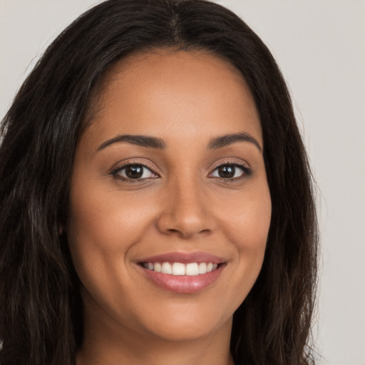 Joyful white young-adult female with long  brown hair and brown eyes