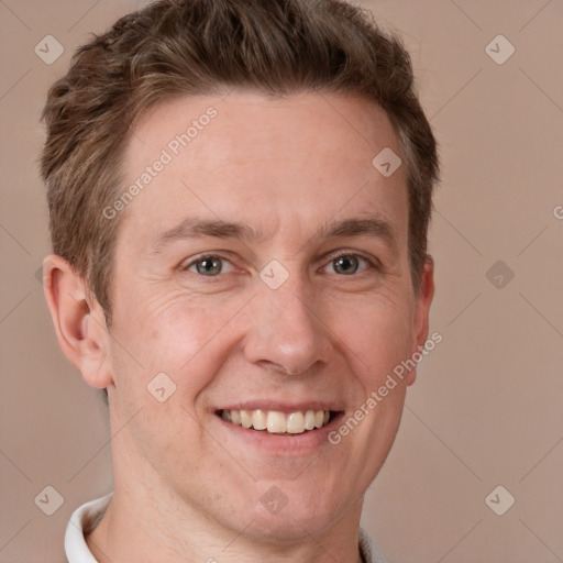 Joyful white adult male with short  brown hair and grey eyes