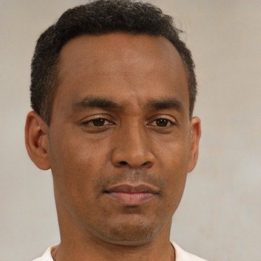 Neutral latino adult male with short  brown hair and brown eyes