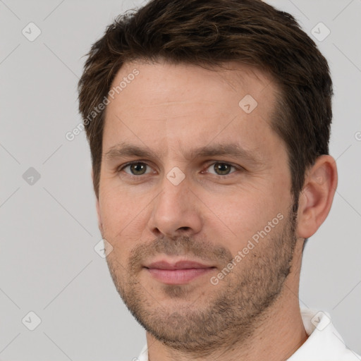 Joyful white adult male with short  brown hair and brown eyes