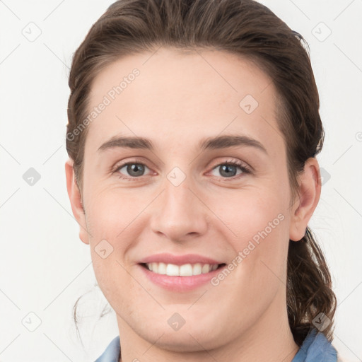 Joyful white young-adult female with medium  brown hair and grey eyes