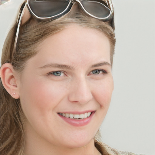 Joyful white young-adult female with long  brown hair and blue eyes