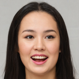 Joyful asian young-adult female with long  brown hair and brown eyes