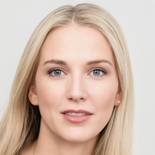 Joyful white young-adult female with long  brown hair and blue eyes