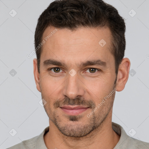 Joyful white young-adult male with short  brown hair and brown eyes