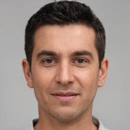 Joyful white young-adult male with short  brown hair and brown eyes