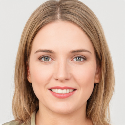 Joyful white young-adult female with medium  brown hair and green eyes