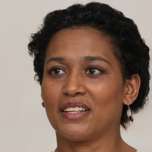 Joyful black adult female with short  black hair and brown eyes