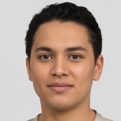 Joyful latino young-adult male with short  black hair and brown eyes