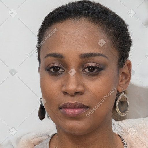 Joyful black young-adult female with short  brown hair and brown eyes