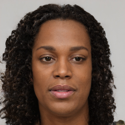 Neutral black young-adult female with long  brown hair and brown eyes