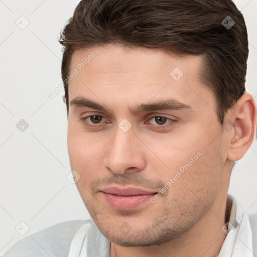 Joyful white young-adult male with short  brown hair and brown eyes