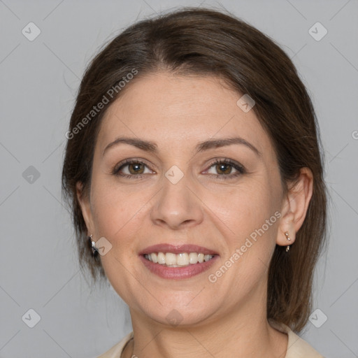 Joyful white adult female with medium  brown hair and grey eyes