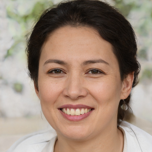 Joyful white adult female with medium  brown hair and brown eyes