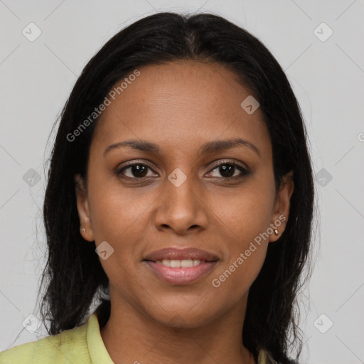 Joyful black young-adult female with long  brown hair and brown eyes