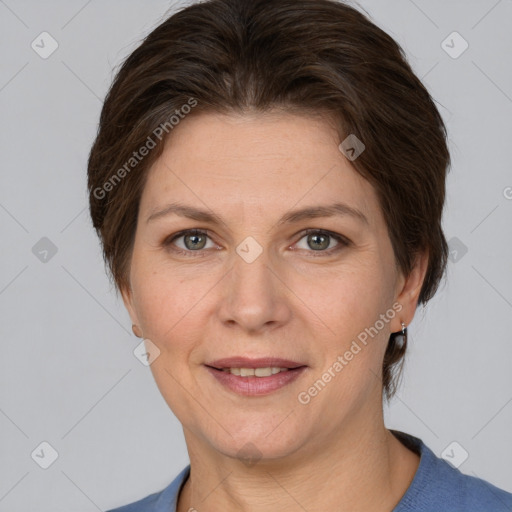 Joyful white adult female with medium  brown hair and grey eyes