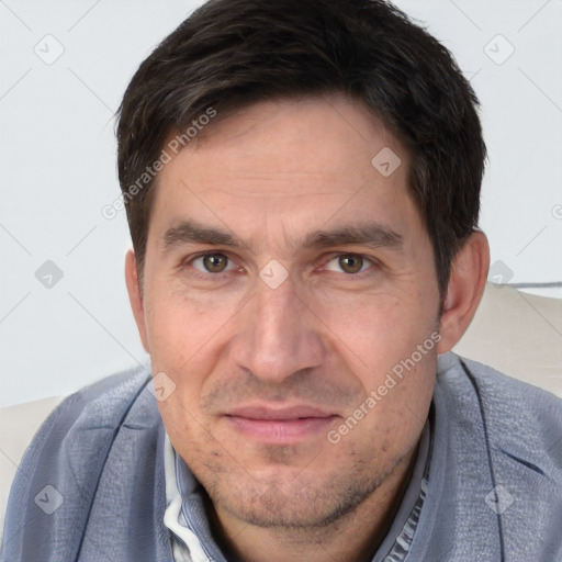 Joyful white adult male with short  brown hair and brown eyes