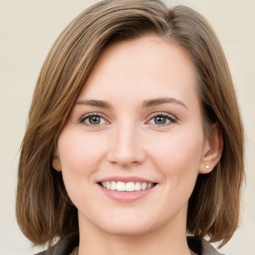 Joyful white young-adult female with medium  brown hair and green eyes