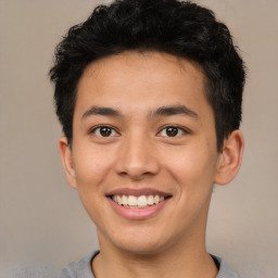 Joyful latino young-adult male with short  brown hair and brown eyes