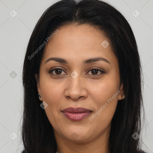 Joyful latino adult female with long  brown hair and brown eyes