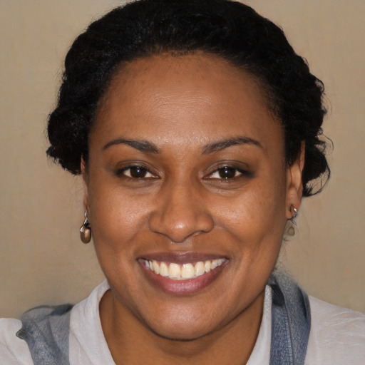 Joyful black young-adult female with short  brown hair and brown eyes