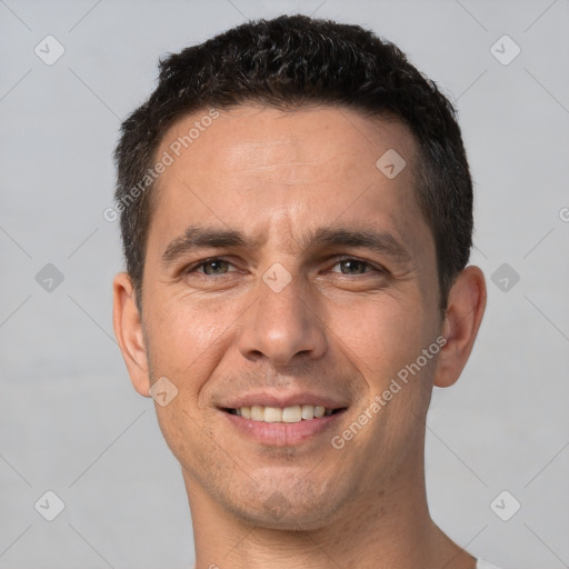 Joyful white adult male with short  brown hair and brown eyes