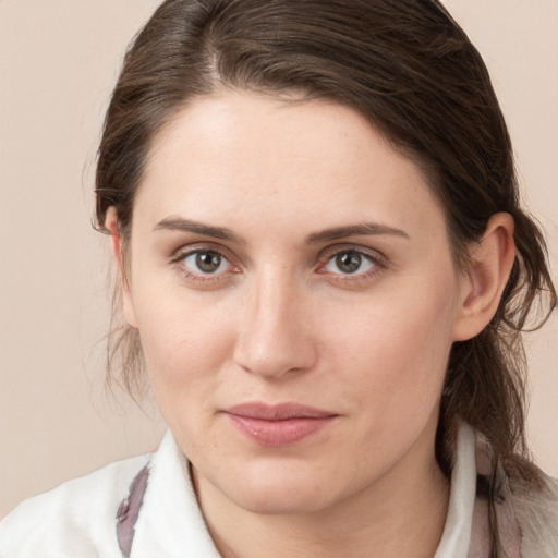 Joyful white young-adult female with medium  brown hair and grey eyes