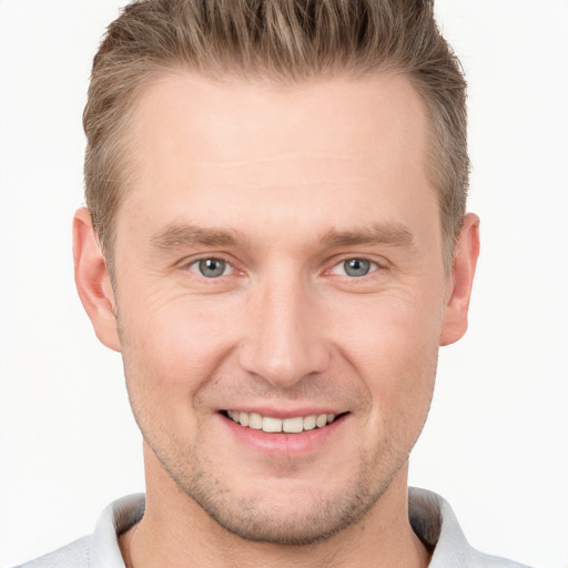 Joyful white young-adult male with short  brown hair and grey eyes