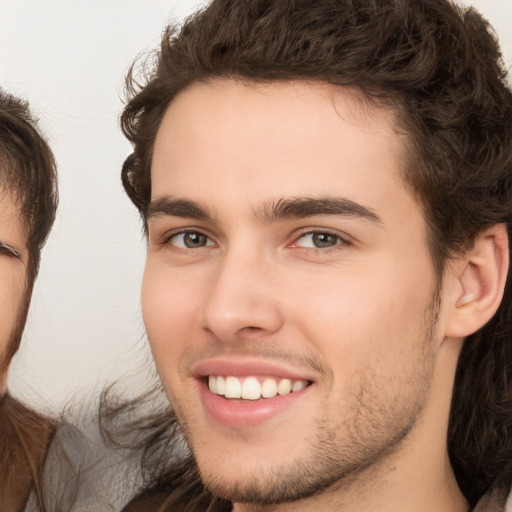 Joyful white young-adult male with medium  brown hair and brown eyes