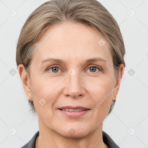 Joyful white adult female with medium  brown hair and grey eyes