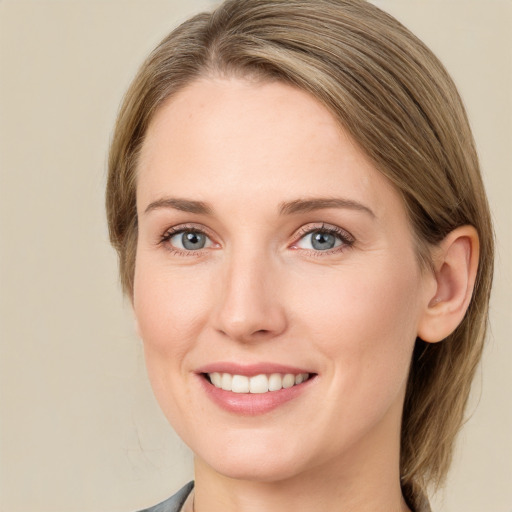 Joyful white young-adult female with medium  brown hair and grey eyes