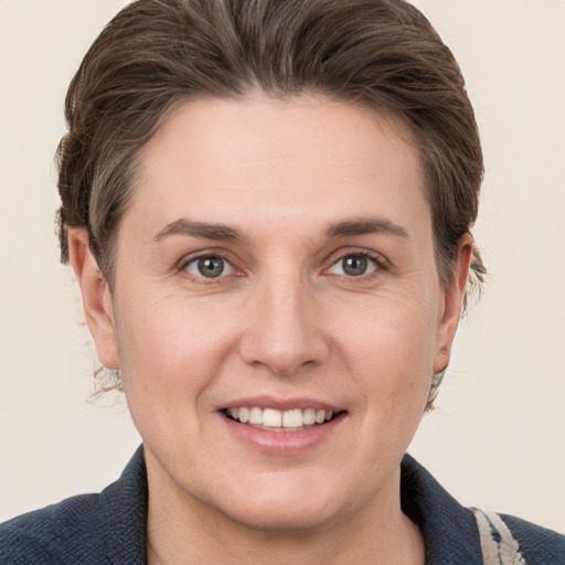 Joyful white young-adult female with short  brown hair and grey eyes