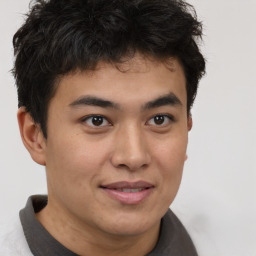 Joyful latino young-adult male with short  brown hair and brown eyes