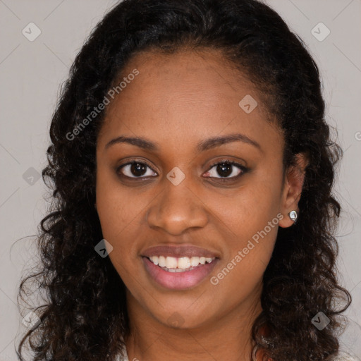 Joyful black young-adult female with long  brown hair and brown eyes