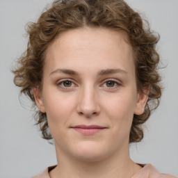 Joyful white young-adult female with medium  brown hair and green eyes