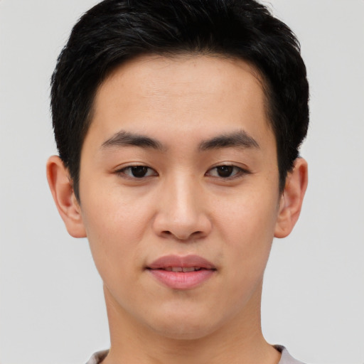 Joyful asian young-adult male with short  black hair and brown eyes