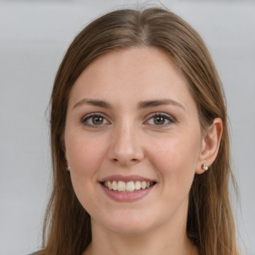 Joyful white young-adult female with long  brown hair and grey eyes