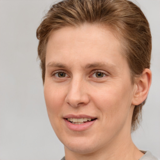 Joyful white adult female with short  brown hair and grey eyes