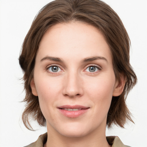 Joyful white young-adult female with medium  brown hair and green eyes