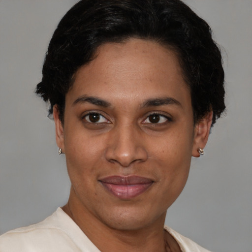 Joyful latino young-adult female with short  brown hair and brown eyes